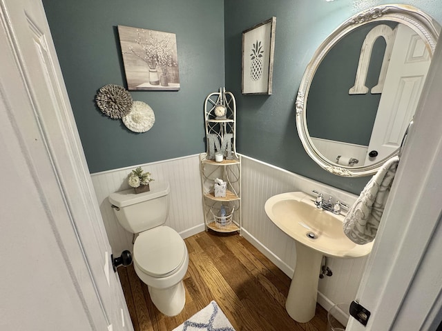 bathroom featuring wood-type flooring and toilet