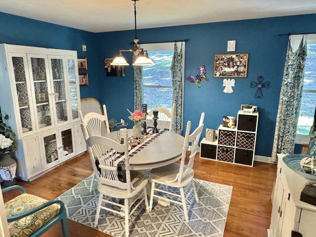 dining room featuring hardwood / wood-style floors and an inviting chandelier