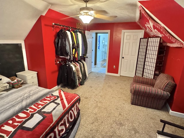 bedroom featuring carpet flooring, vaulted ceiling, and ceiling fan