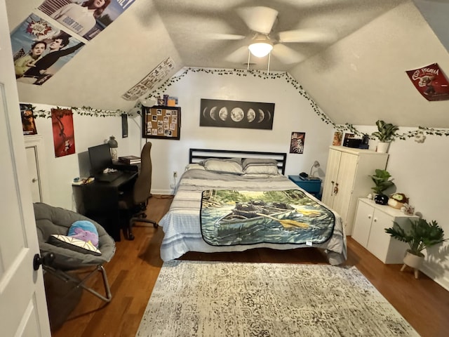 bedroom featuring hardwood / wood-style floors, a textured ceiling, ceiling fan, and lofted ceiling