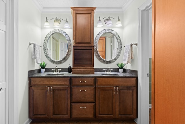 full bathroom featuring double vanity, tile patterned flooring, crown molding, and a sink