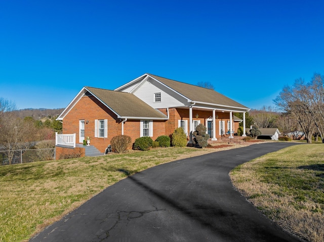 view of front of property with a front yard and brick siding