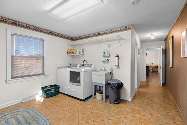 laundry room with light tile patterned floors, visible vents, a textured ceiling, and independent washer and dryer