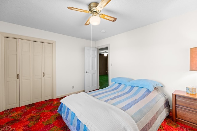 bedroom featuring carpet, ceiling fan, and a closet