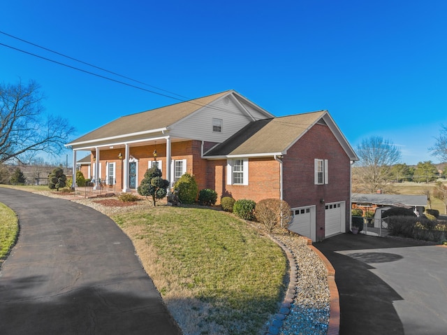 neoclassical home with driveway, an attached garage, a front lawn, a porch, and brick siding