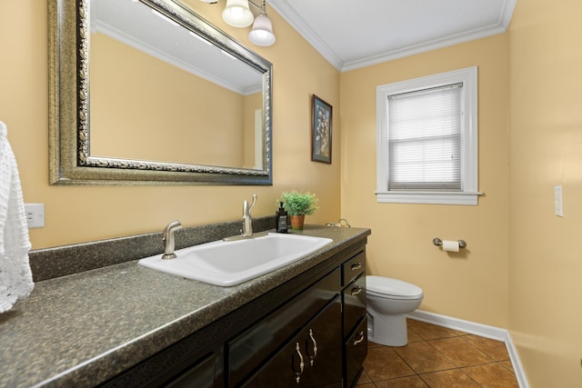 bathroom featuring tile patterned flooring, toilet, vanity, baseboards, and crown molding