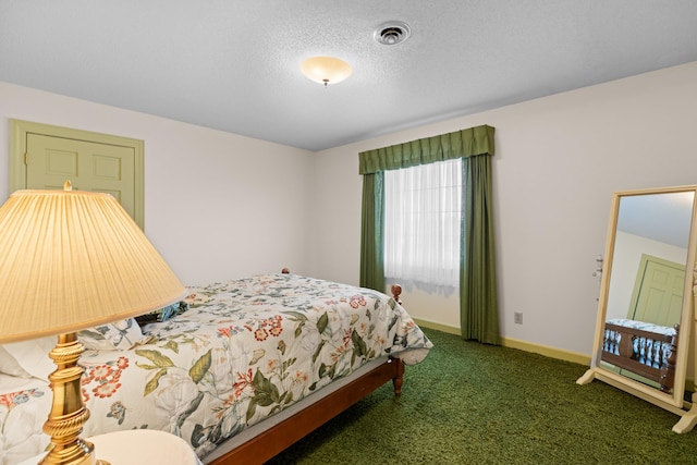 carpeted bedroom with baseboards, visible vents, and a textured ceiling