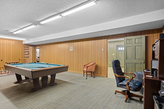 playroom featuring carpet floors, pool table, a textured ceiling, and wooden walls