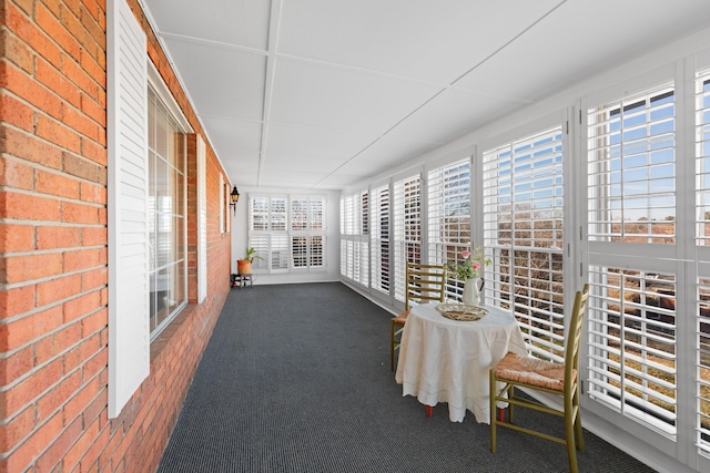 unfurnished sunroom featuring a wealth of natural light and a paneled ceiling