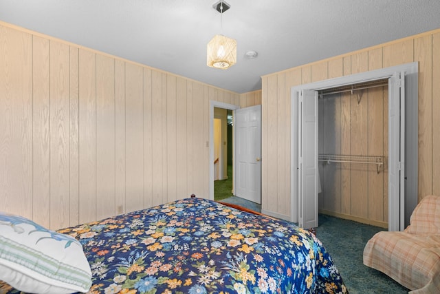 bedroom with a closet, wood walls, and carpet flooring