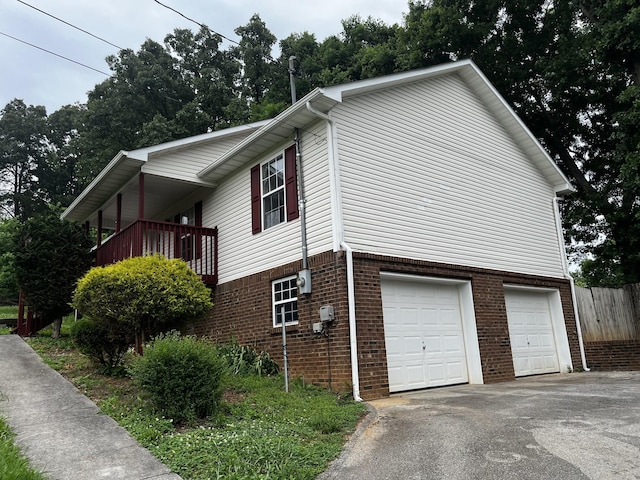 view of home's exterior with a garage and a balcony