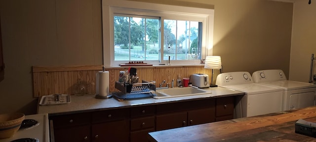 washroom with sink and washing machine and clothes dryer