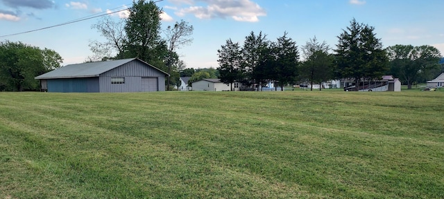 view of yard featuring a garage and an outdoor structure