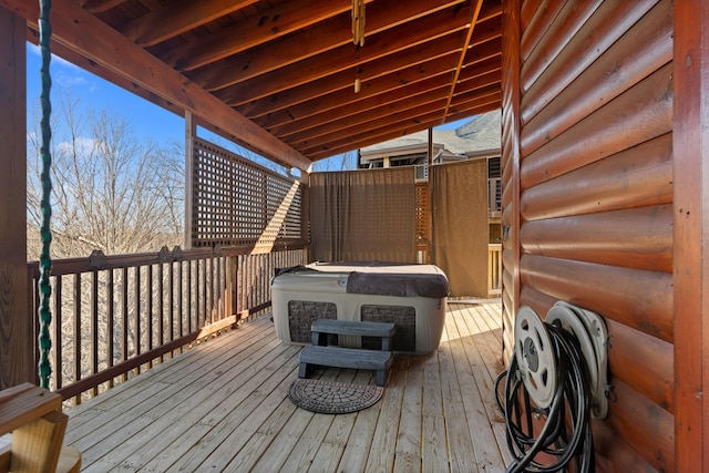 wooden deck featuring a hot tub