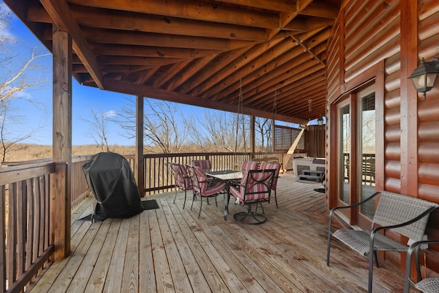 deck with area for grilling and outdoor dining space