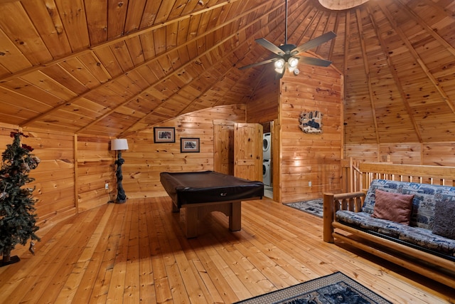 playroom with hardwood / wood-style floors, wood ceiling, wooden walls, and stacked washer / drying machine