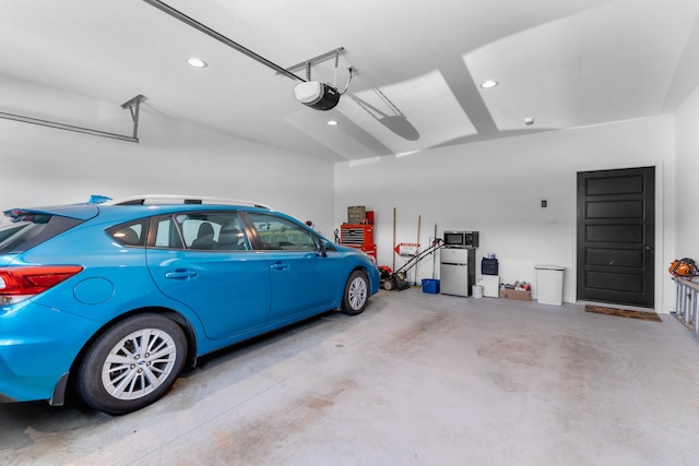 3099 Bridgewater Blvd, Morristown, TN 37814 - garage with a garage door opener, recessed lighting, and freestanding refrigerator