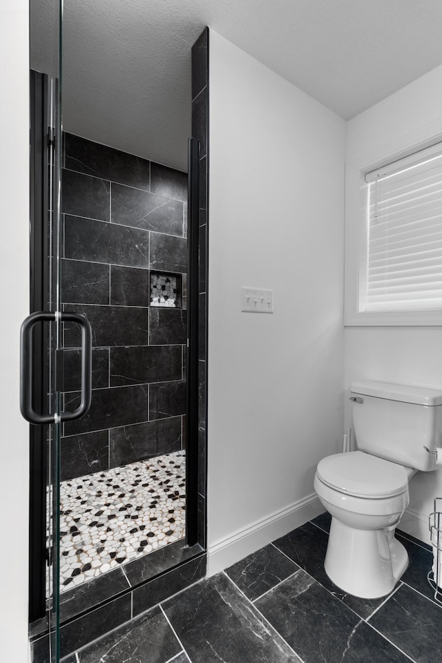 3099 Bridgewater Blvd, Morristown, TN 37814 - bathroom featuring toilet, baseboards, a stall shower, and marble look tiles