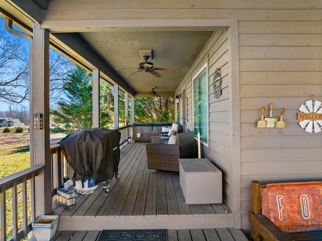deck featuring grilling area and ceiling fan