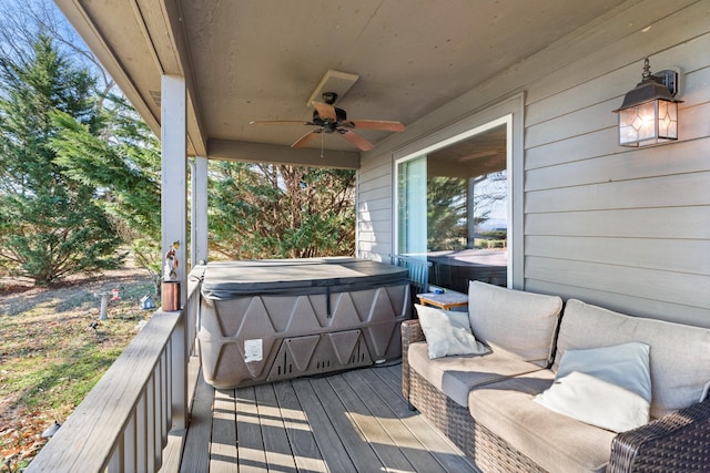 wooden deck featuring a hot tub and ceiling fan