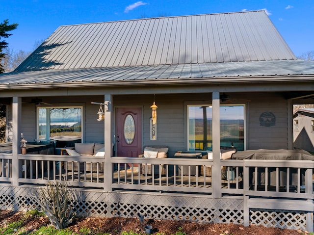 view of front of home featuring a deck, ceiling fan, and metal roof