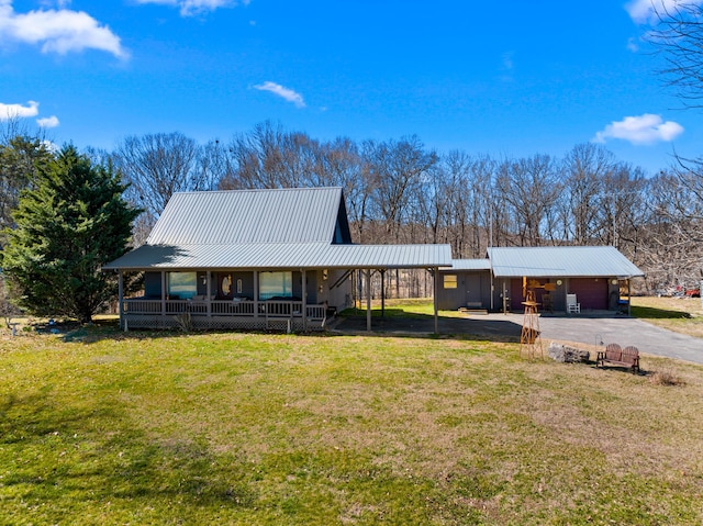 view of front facade featuring metal roof, a porch, aphalt driveway, a carport, and a front lawn