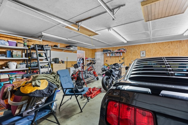 garage featuring wood walls