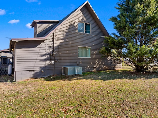 view of home's exterior featuring cooling unit, a lawn, and crawl space
