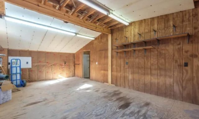 interior space with wooden walls and vaulted ceiling