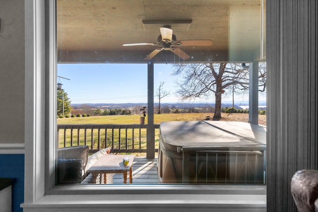 deck featuring ceiling fan and a hot tub