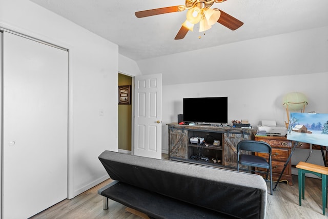 interior space with wood finished floors, lofted ceiling, and a ceiling fan