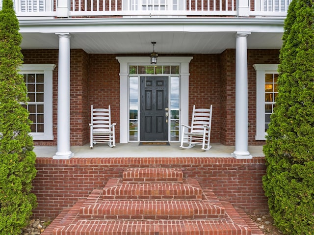 property entrance with a balcony and a porch