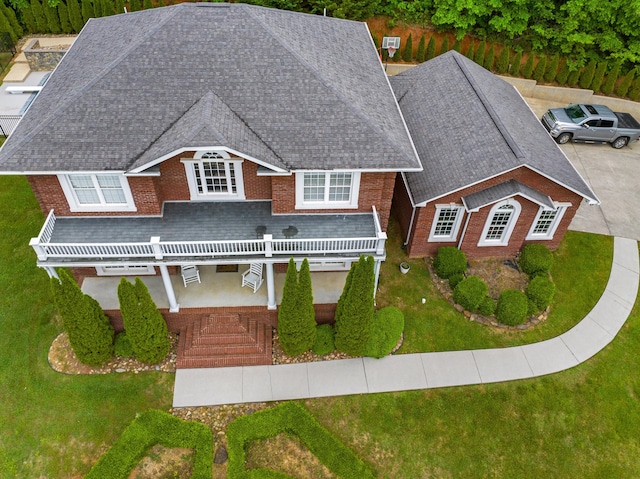 view of front of property featuring roof with shingles and a front yard
