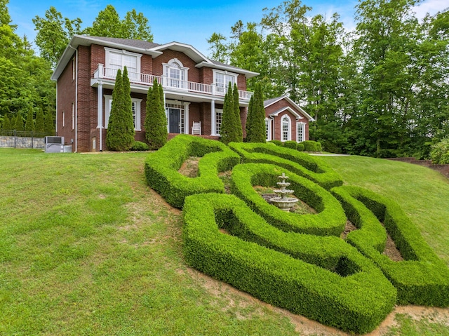colonial home with brick siding and a balcony