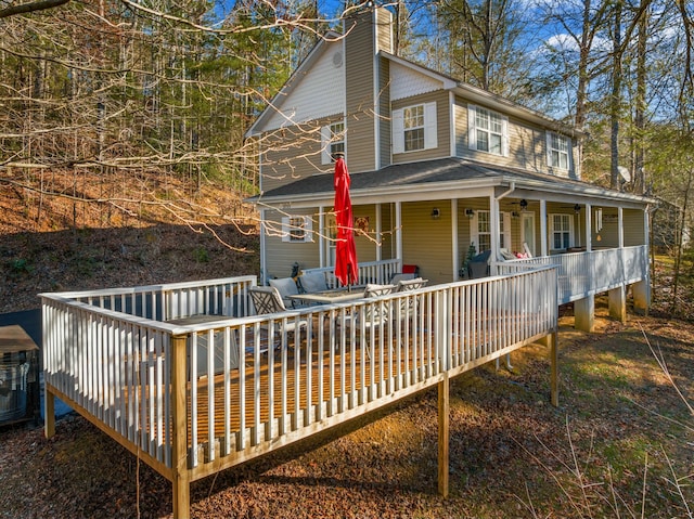 exterior space featuring covered porch and a deck