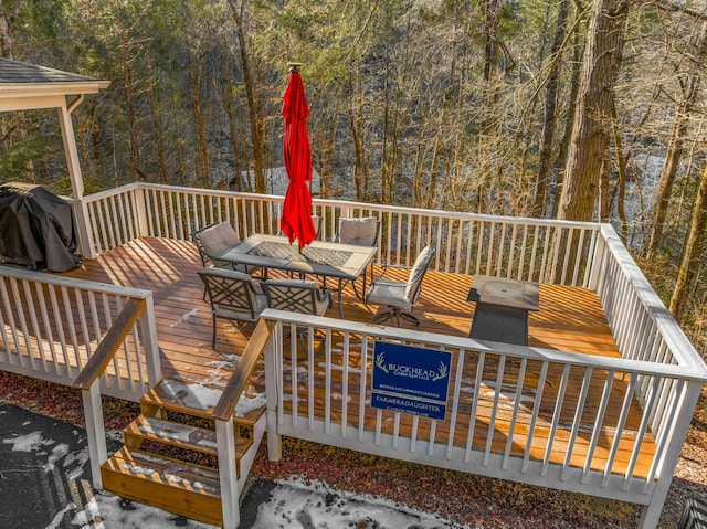 wooden terrace with a grill