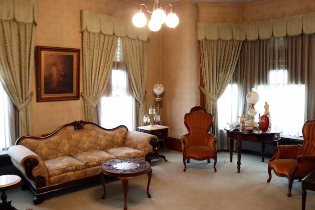 sitting room featuring light colored carpet and a chandelier