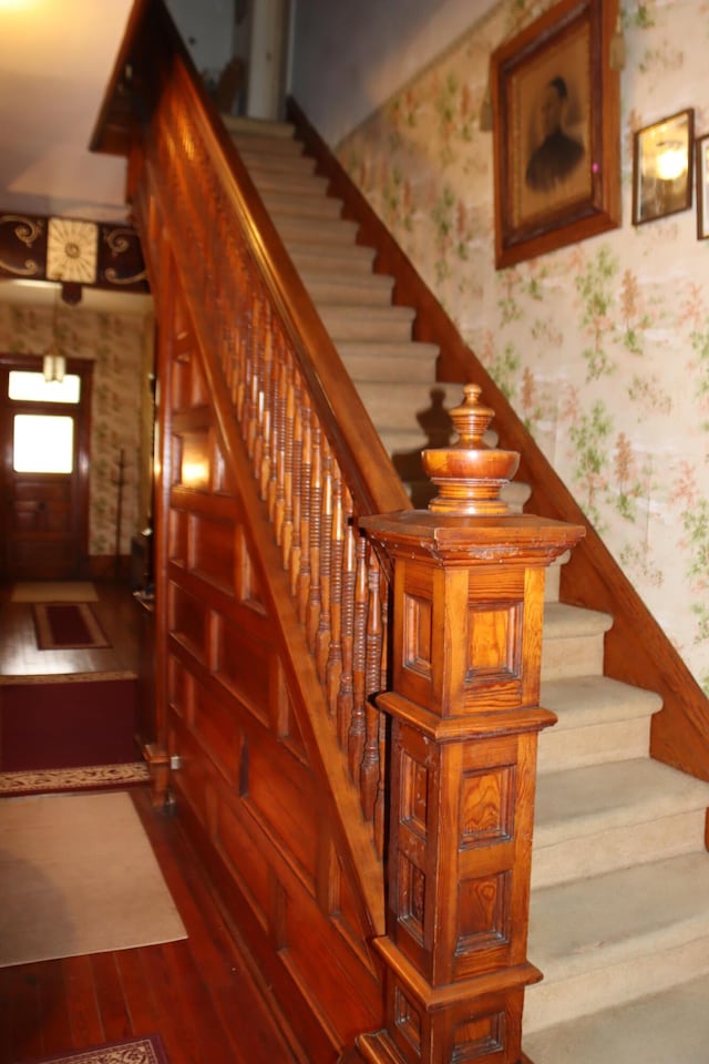 stairs featuring hardwood / wood-style floors