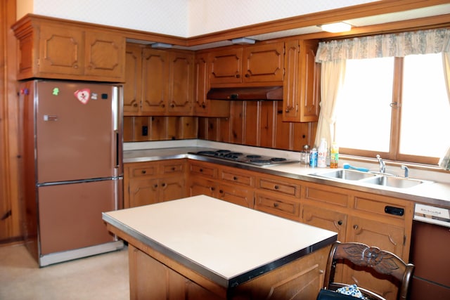 kitchen with a center island, white appliances, and sink