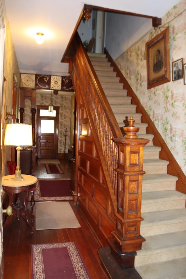 staircase with hardwood / wood-style floors