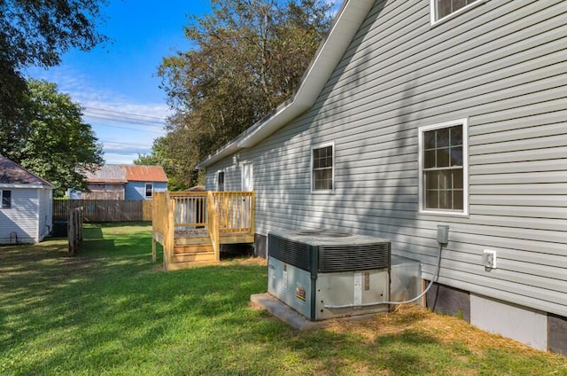 view of yard with a deck and central air condition unit