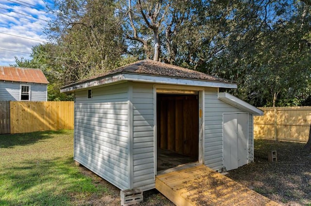 view of outbuilding with a yard