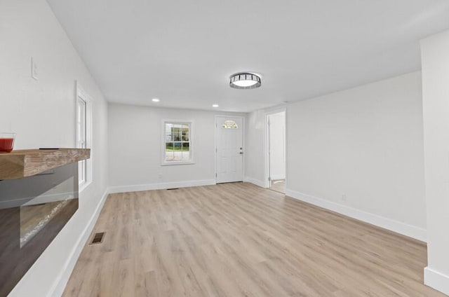 unfurnished living room featuring light wood-type flooring