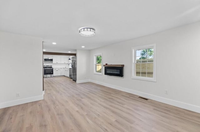 unfurnished living room featuring light hardwood / wood-style flooring