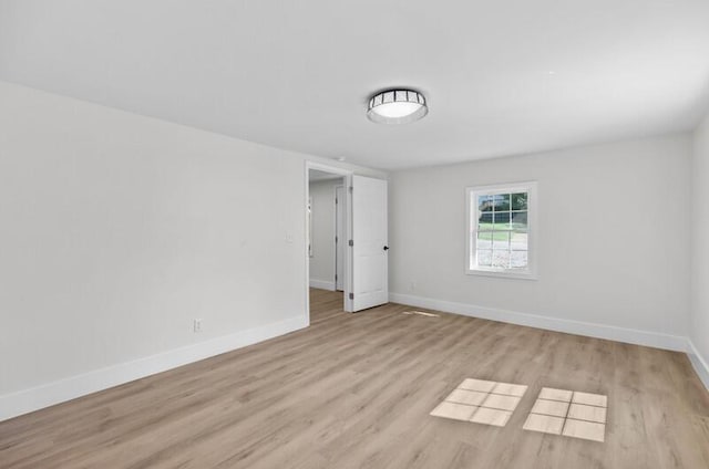 unfurnished room with light hardwood / wood-style floors