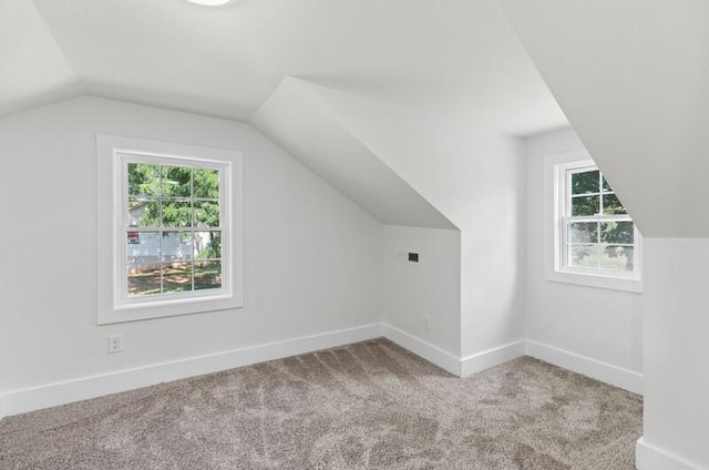 bonus room with carpet flooring and lofted ceiling