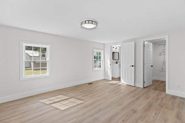 unfurnished bedroom featuring light wood-type flooring