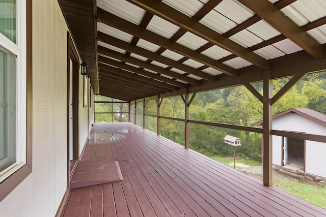 wooden deck featuring a shed