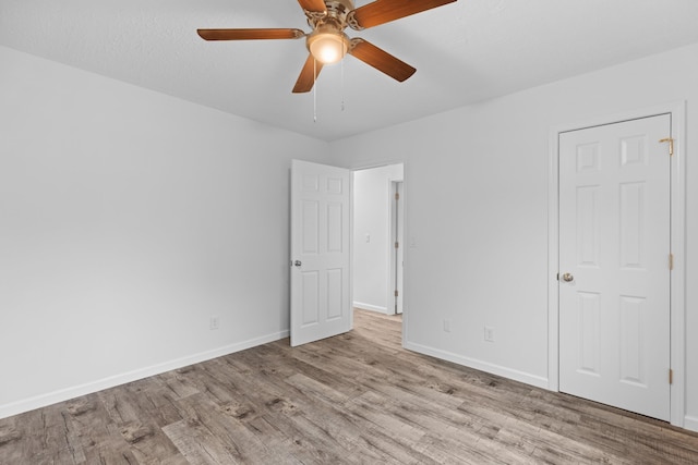 unfurnished room featuring ceiling fan and light wood-type flooring