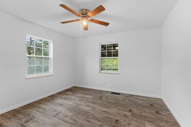 unfurnished room with hardwood / wood-style flooring and ceiling fan